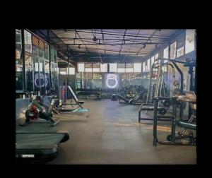 a gym with rows of treadmills and machines at The Cozy Cube at Tsavo Sunset in Nairobi