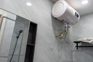 a bathroom with a shower and a camera on the wall at Résidence Madior C1 in Dakar +1 photo