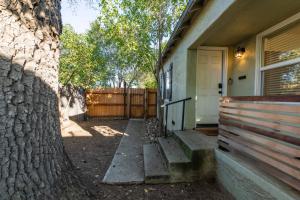 a house with a tree next to a fence at Park Street Pad in Paso Robles