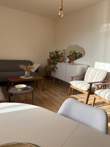 a living room with a couch and chairs and a table at TREFOIL in Lori Berd