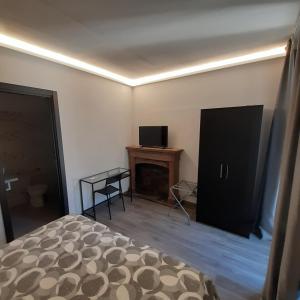 a bedroom with a bed and a television and a table at Angela's house in Sulmona