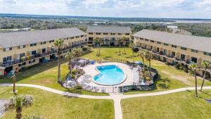 an aerial view of a resort with a pool and buildings at St Augustine Beachfront Condo with Ocean Views in Saint Augustine Beach +27 photos
