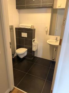 a bathroom with a toilet and a sink at Harbour Stay Volendam in Volendam +17 photos