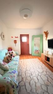 a living room with a couch with a dog sitting on it at Paraíso a Dois em Estremoz in Estremoz