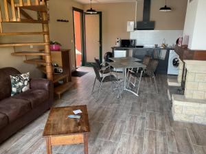 a living room with a couch and a table at Logement au bord de l eau in Dordives
