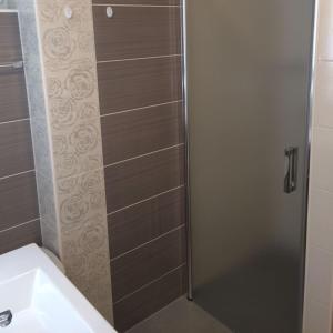 a bathroom with a shower with a toilet and a sink at Angelina Apartment in Zaprešić