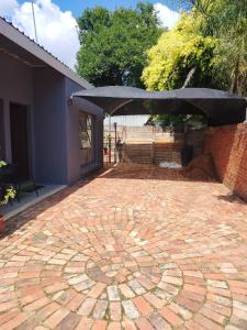 a brick patio with a circle in the middle at SinoVilla397 in Pretoria