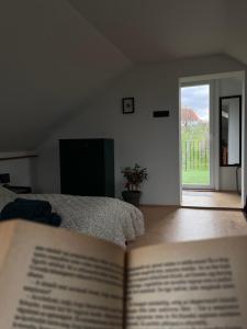 a book sitting on top of a bed in a bedroom at Cseligevi Vendégház in Szekszárd