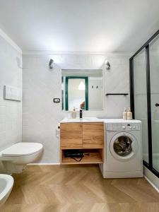 a bathroom with a washing machine and a sink at Il Vicoletto Marino in Marino +20 photos