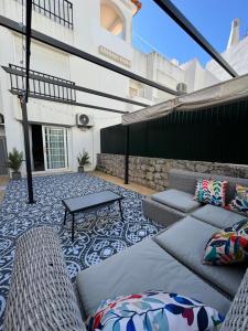 a patio with couches and a table on a building at Seabreeze T3 in Carvoeiro
