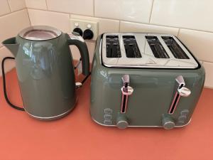 two toasters sitting next to each other on a counter at Manor on McIntyre in Horsham