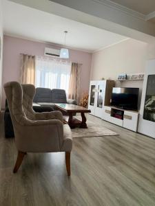 a living room with a couch and a table at AS Holiday Home in Ljubuški