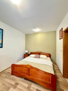 a bedroom with a large wooden bed in it at AS Holiday Home in Ljubuški +24 photos