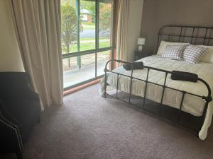 a bedroom with a bed and a large window at Manor on McIntyre in Horsham