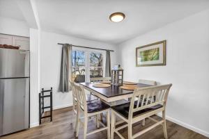 a kitchen with a table and chairs and a refrigerator at 113 Madison Ave, Cuyahoga Falls in Cuyahoga Falls