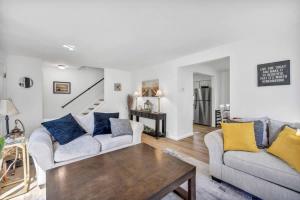 a living room with two couches and a table at 113 Madison Ave, Cuyahoga Falls in Cuyahoga Falls