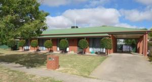 a large building with a green roof and a driveway at Manor on McIntyre in Horsham