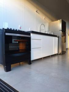 a kitchen with a sink and a stove at Recanto Três Rios in Santa Clara dʼOeste