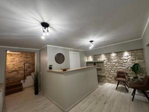 a living room with a stone wall and a counter at I due archi in Norcia