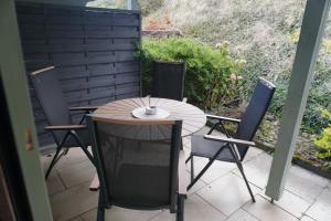 a wooden table and chairs on a patio at Ferienwohnung EGS in Lahr