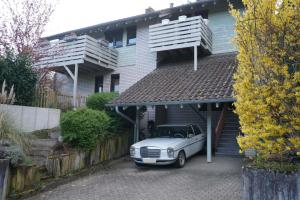 a white car parked in front of a house at Ferienwohnung EGS in Lahr