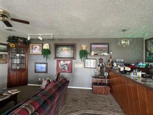 a room with a bar with a couch in it at Cherokee Inn in Cherokee