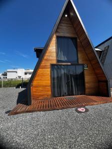 a small house with a large window on the front at Chalé Rosa dos Ventos in Itapoa