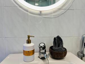 a bottle of soap sitting on a sink in a bathroom at Sunny Nest 1 in Vaasa +17 photos