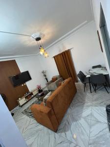 a living room with a couch and a table at Résidence Eden2 in San-Pédro