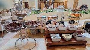 a buffet of food with bowls and other food items at Centrum Guide Apartman Hévíz in Hévíz
