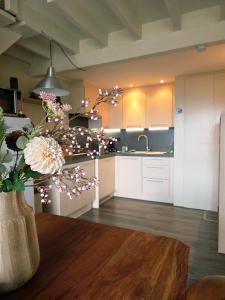 a kitchen with a vase of flowers on a table at Slow Stay Coo in Stavelot