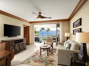 a living room with a couch and a tv at Hyatt Vacation Club at Ka'anapali Beach in Lahaina