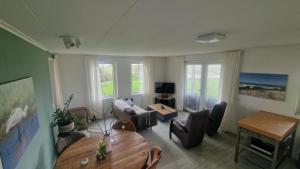 a living room with a couch and a table at 't Olde Land in Den Burg