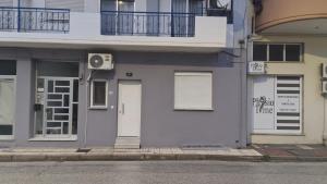 a white building with a door and a balcony at Casa Via Egnatia in Komotini