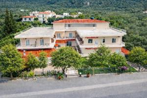 a house on a hill with trees in front of it at Πανθεον in Kamena Vourla