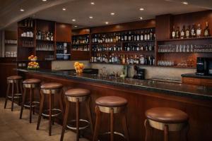 a bar with brown stools in a room at Πανθεον in Kamena Vourla