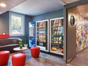a fast food restaurant with two refrigerators and a table at hotelF1 Roissy CDG Pn2 in Roissy-en-France
