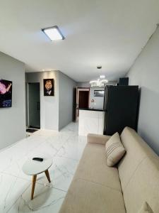 a living room with a couch and a table at Flats Sucesso in Teresina