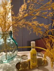 a bottle of honey and two glasses on a table at Philosofia in Naples