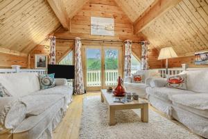 a living room with white furniture and a wooden ceiling at 3 Bed in Little Petherick oc-maplod in Little Petherick
