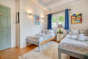 a bedroom with two beds and a window at 3 Bed in Little Petherick oc-maplod in Little Petherick