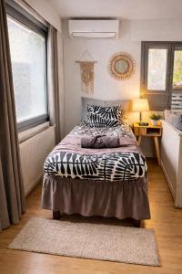 a bedroom with a bed with a zebra blanket at Sunny Nest 1 in Vaasa