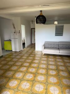a living room with a couch and a kitchen at Chez Charline in Saint-Claude +4 photos