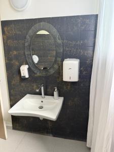 a bathroom with a sink and a mirror at Chez Charline in Saint-Claude
