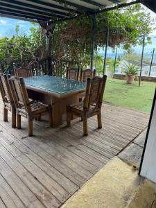 a table and chairs on a wooden deck at Chez Charline in Saint-Claude