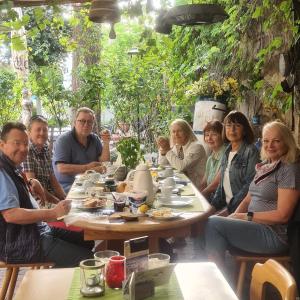 a group of people sitting around a table at Gasthaus Korfu in Edenkoben