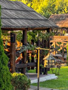 a wooden gazebo with a bird house in a garden at Orlyne Gnizdo in Chernivtsi