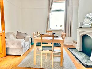 a living room with a table and a couch at New Brighton Beach in Wallasey
