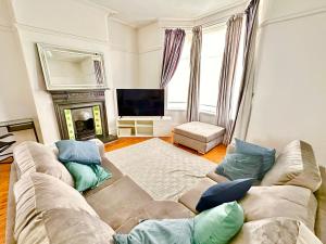 a living room with a couch and a fireplace at New Brighton Beach in Wallasey