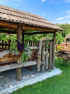 a wooden gazebo with flowers on it at Orlyne Gnizdo in Chernivtsi
